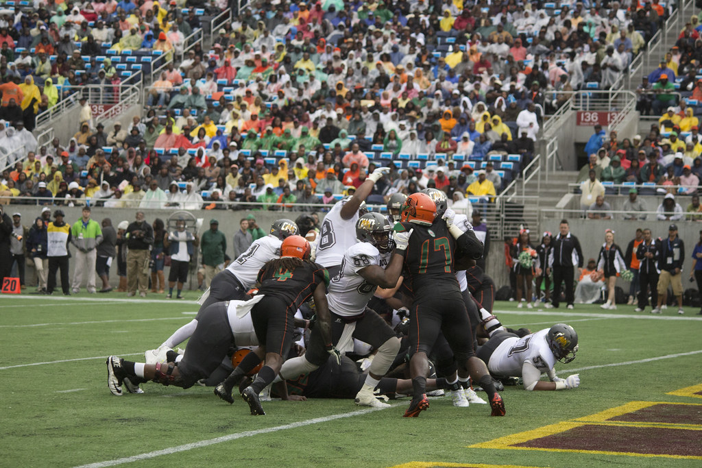 American football players in a tackle pile on the field