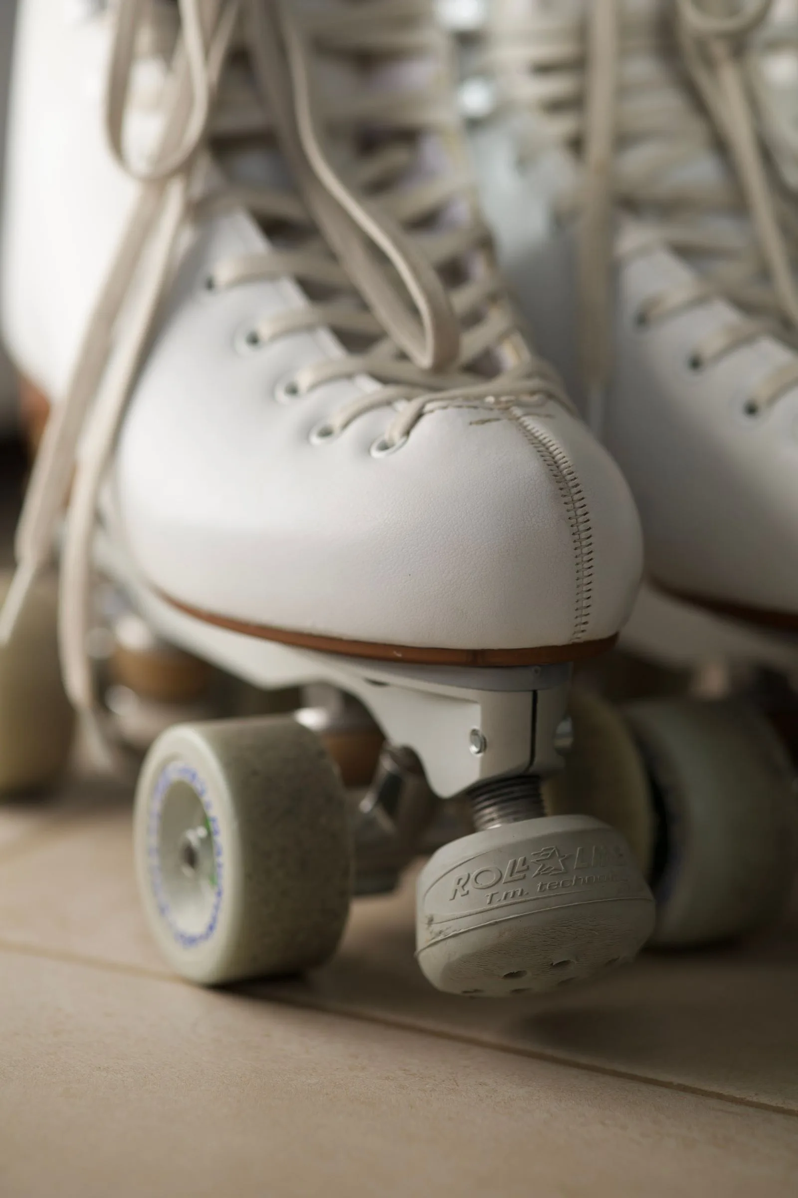 Pair of white vintage roller skates with laces