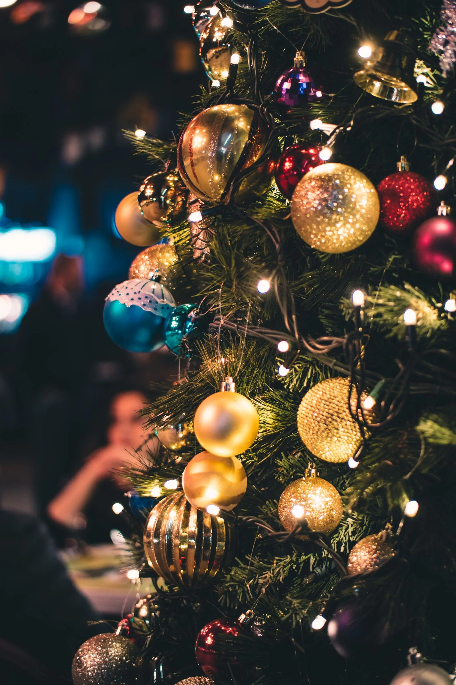 Close-up of a Christmas tree hung with ornaments and lights